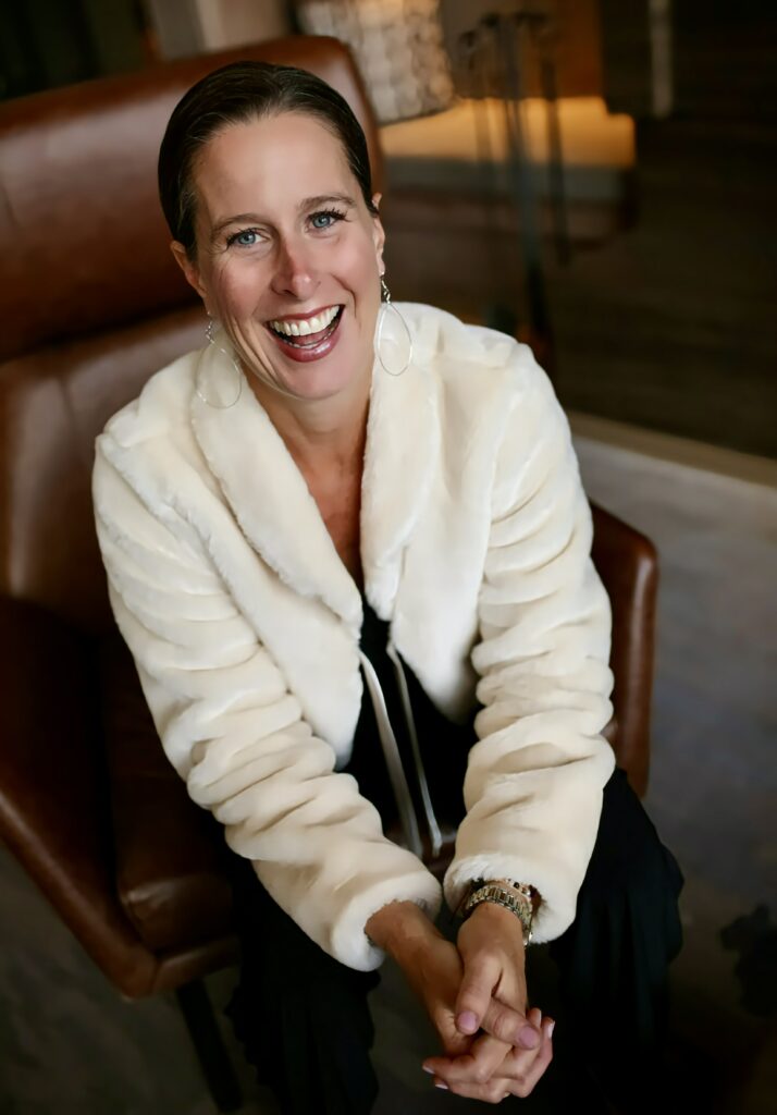 Montana Life Coach Christine Seager sitting on a chair looking happy and eager to help you